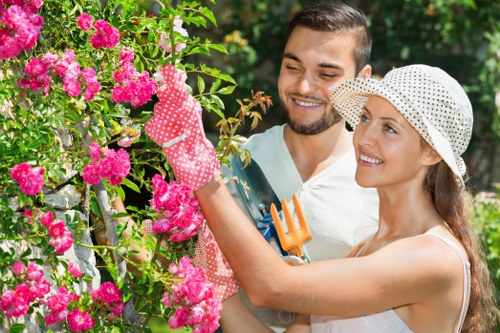 Gardener carrying out safe outdoor maintenance with protective equipment